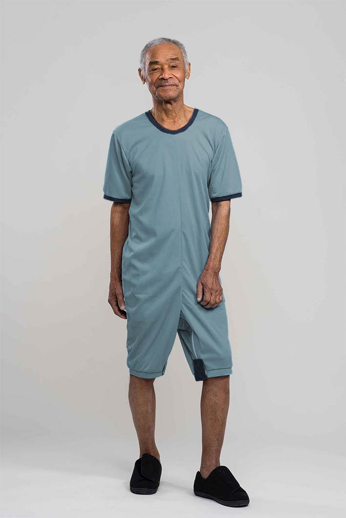 Adaptive short legs onesie designed for people suffering from dementia. A zipper on the back of the garment prevents the wearer from undressing. A large, zippered crotch opening facilitates diaper changes. Durable soft mesh knit dries quickly. Can be wo