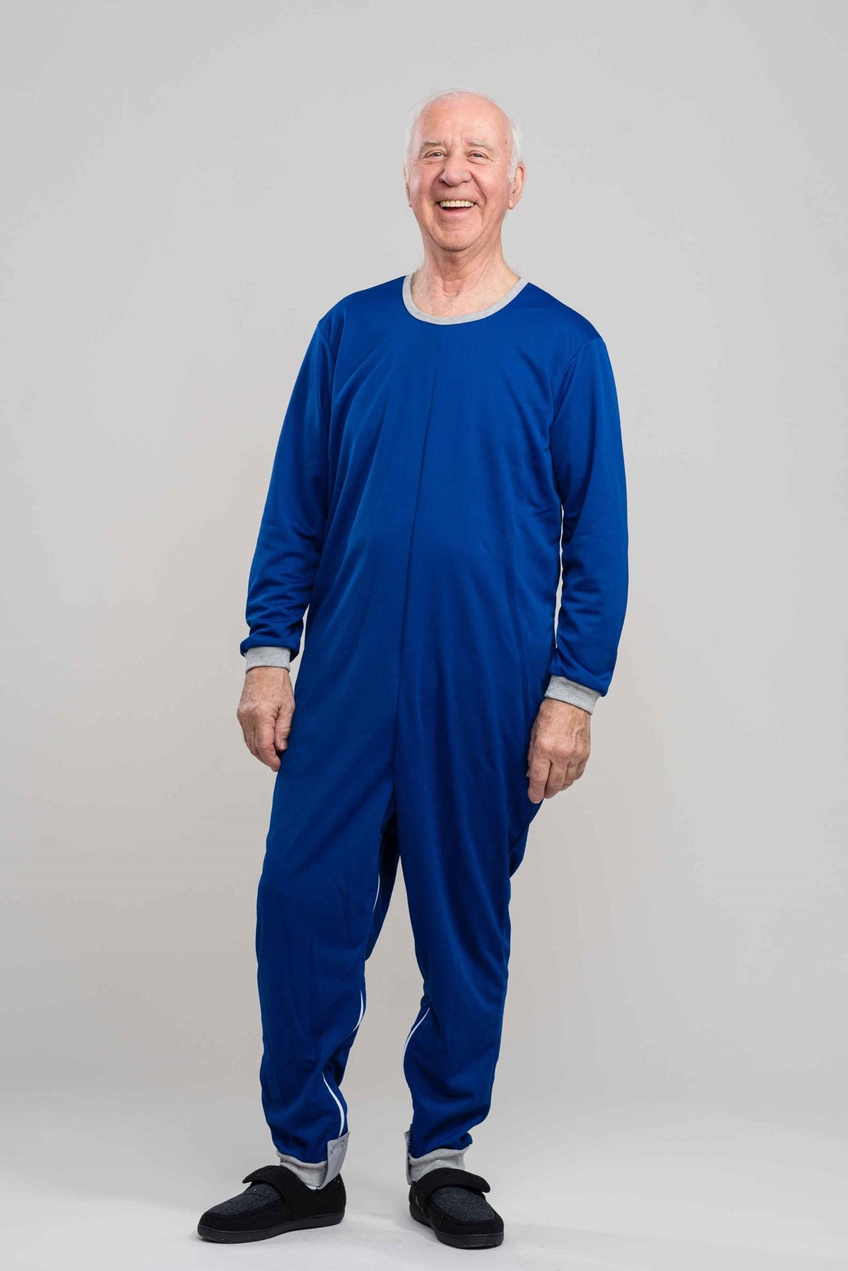 Adaptive long legs onesie designed for people suffering from dementia. A zipper on the back of the garment prevents the wearer from undressing. A large, zippered crotch opening facilitates diaper changes. Durable soft mesh knit dries quickly. Can be wor