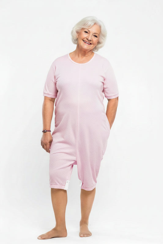 Adaptive short legs onesie designed for people suffering from dementia. A zipper on the back of the garment prevents the wearer from undressing.  A large, zippered crotch opening facilitates diaper changes.  Durable soft mesh knit dries quickly. Can be wo