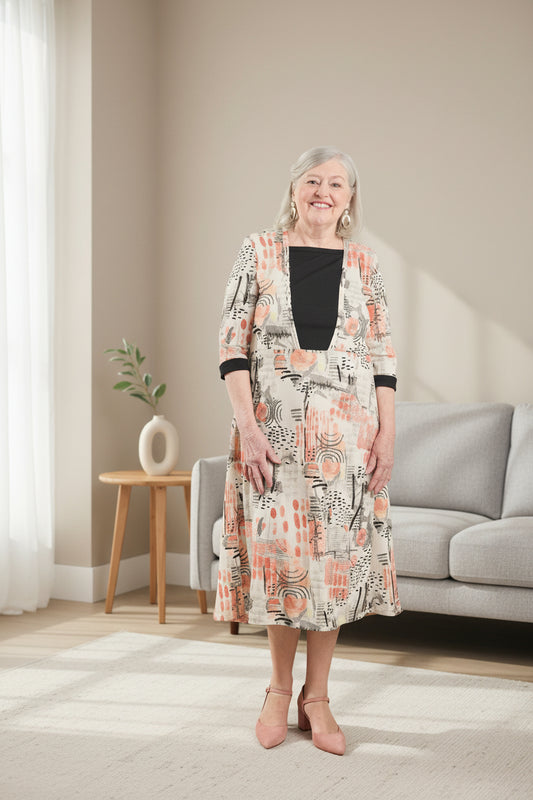This adaptive dress features 3/4 sleeves and a soft stretch knit, providing comfort and ease of movement. The open back design and metal snaps make for quick and easy dressing, perfect for those with limited mobility.